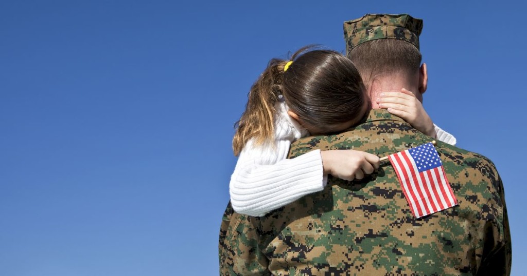 Soldier military veterans hugging family child