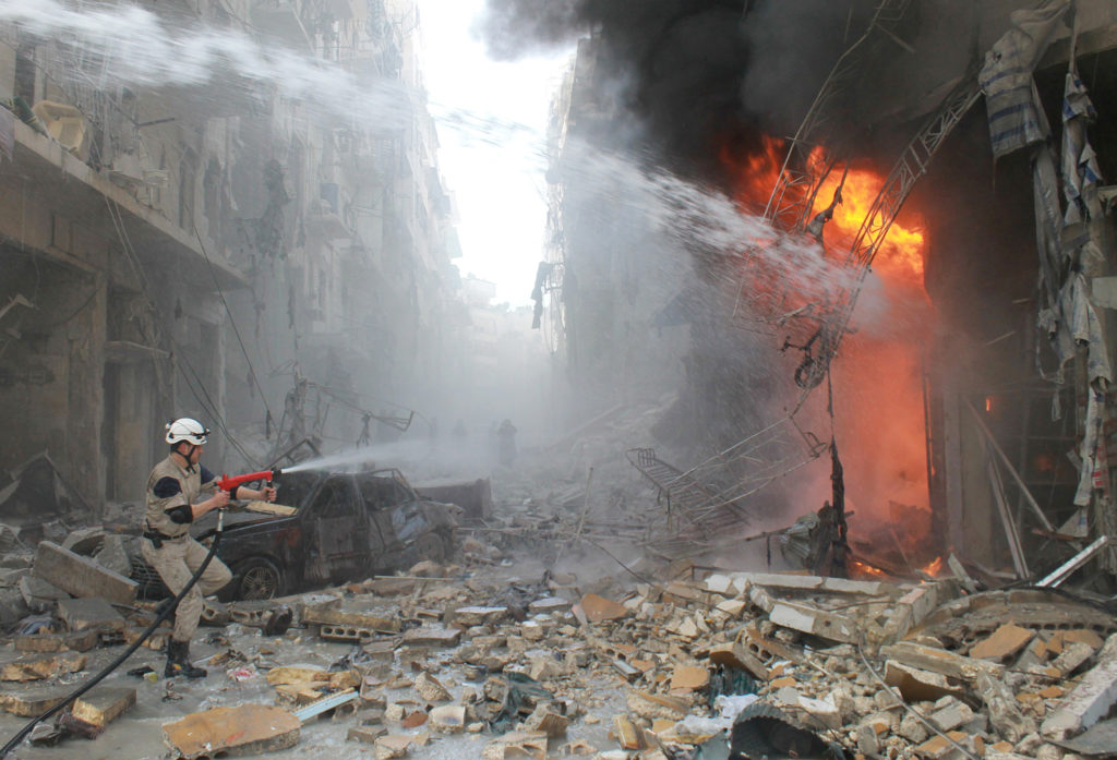 Syrian emergency personnel extinguish a