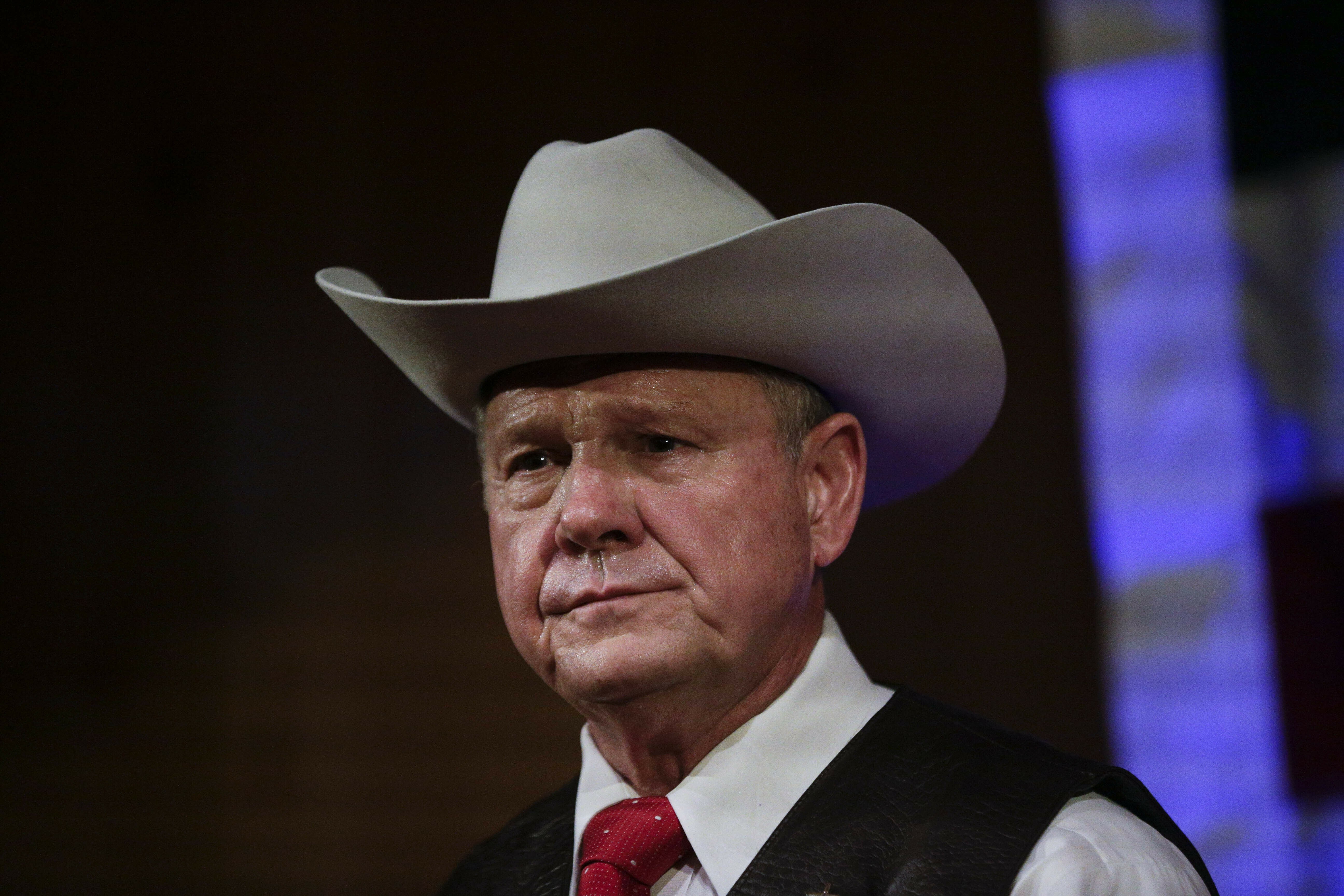 FILE - In this Sept. 25, 2017, file photo, Roy Moore speaks at a rally in Fairhope, Ala. President Donald Trump is warning that the “consequences will be devastating” if failed Alabama Republican Roy Moore runs again for a senate seat in 2020. Moore lost in the once-reliably red state in a 2017 special election amid sexual misconduct allegations which he denied. (AP Photo/Brynn Anderson, File)